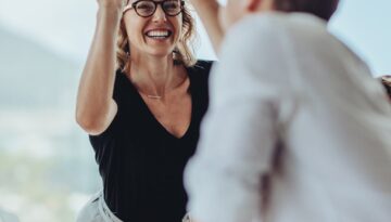 Businesswoman giving a high five to a colleague in meeting
